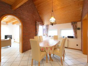 a dining room with a table and chairs at Holiday Home Riedehuus by Interhome in Norddeich