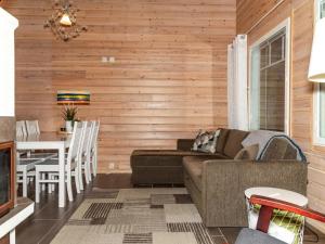 a living room with a couch and a table at Holiday Home Ylläs-eeli green house c2 by Interhome in Ylläsjärvi