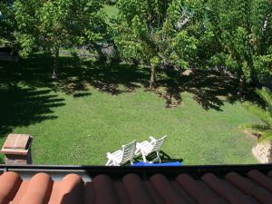 two chairs sitting on the grass in a yard at Villa Villa Chiara by Interhome in Forte dei Marmi