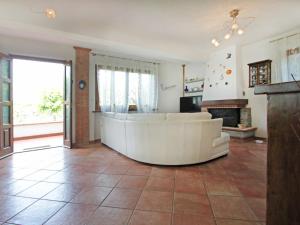 a living room with a white couch and a fireplace at Villa Villa Chiara by Interhome in Forte dei Marmi