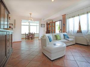 a living room with a couch and a table at Villa Villa Chiara by Interhome in Forte dei Marmi