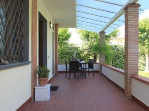 a patio with a pergola with a table and chairs at Villa Villa Chiara by Interhome in Forte dei Marmi