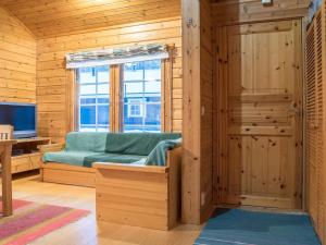 a living room with a couch and a window at Holiday Home Lomaylläs h109 -pistopolku 1 a by Interhome in Ylläsjärvi