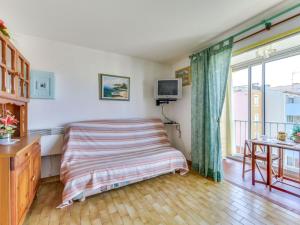 a bedroom with a bed and a desk and a tv at Apartment Plein Soleil-1 by Interhome in Cap d'Agde