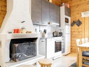 a kitchen with a fireplace in the middle of a room at Holiday Home Lomaylläs h113-pistopolku 5a by Interhome in Ylläsjärvi