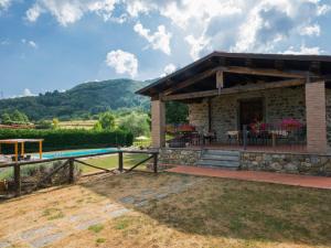 a stone house with a patio and a pool at Holiday Home La Fenice by Interhome in Vitoio