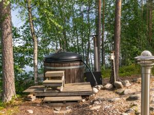 a largeendiaryendiaryendiary device sitting on a wooden platform in a forest at Holiday Home Hot pool cottage ainu by Interhome in Ihamaniemi