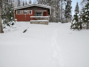 Juhanala的住宿－Holiday Home Lepikko by Interhome，雪中小红小屋,有树