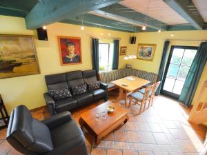 a living room with a couch and a table at Holiday Home Kapitänshaus by Interhome in Groß Zicker