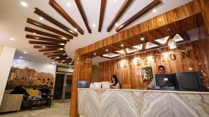 a man and woman sitting at a counter in a restaurant at New Hotel Suhail in Hyderabad