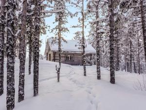 a log cabin in the snow with trees at Holiday Home Ylikyrön mökki by Interhome in Kyrö +19 photos