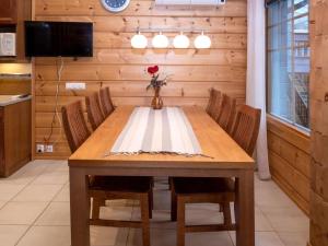 a dining room with a wooden table and chairs at Holiday Home Vuosselin trio b by Interhome in Ruka