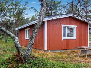 a red building with a picnic table in front of it at Holiday Home Mellaniemi by Interhome in Hietajoensuu
