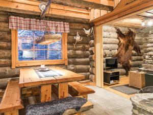a wooden cabin with a table and a window at Holiday Home Operonmukka a 8 by Interhome in Levi