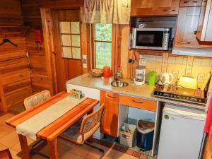 a small kitchen with a table and a sink at Holiday Home Valkonen pohjonen b by Interhome in Levi