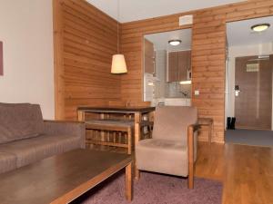 a living room with a couch and a table at Holiday Home Ylläs chalets 3508 by Interhome in Ylläs