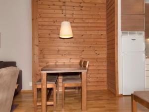 a table and chair in a room with a wall at Holiday Home Ylläs chalets 3508 by Interhome in Ylläs