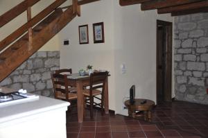 a kitchen with a table and chairs in a room at Case Eleutheria in Petralia Soprana
