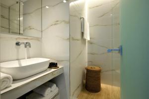 a white bathroom with a sink and a shower at Citrus Exclusive in Agios Nikolaos +34 photos