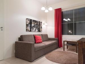 a living room with a couch with a red pillow at Holiday Home Yllästar 3 as 502 by Interhome in Äkäslompolo