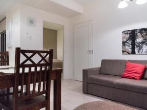 a living room with a couch and a table at Holiday Home Yllästar 3 as 502 by Interhome in Äkäslompolo
