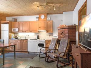 アカスロンポロにあるHoliday Home Kurunkynsi ii by Interhomeのキッチン(木製キャビネット、テーブル、椅子付)