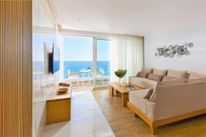 a living room with a couch and a view of the ocean at Citrus Exclusive in Agios Nikolaos
