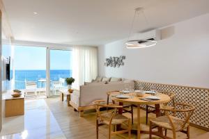 a living room with a table and a couch at Citrus Exclusive in Agios Nikolaos