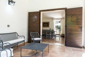 a living room with a couch and chairs and a table at Villa Biancospini - guesthouse Le Case di Aurelia in Castellaneta Marina