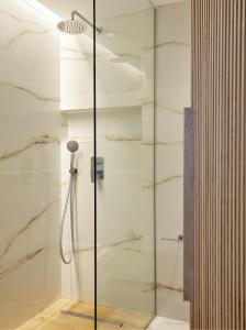 a shower with a glass door in a bathroom at Citrus Exclusive in Agios Nikolaos