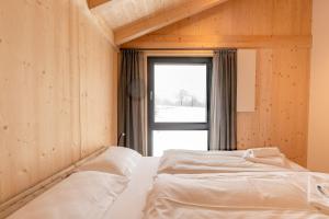 a bedroom with two beds and a window at Chalet Allgäublick in Sonthofen