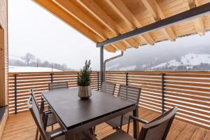 a table and chairs on the balcony of a house at Chalet Allgäublick in Sonthofen