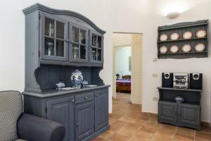a large blue cabinet in a living room at Villa Biancospini - guesthouse Le Case di Aurelia in Castellaneta Marina  +15 photos