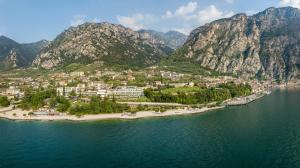 an island in a body of water with mountains at Hotel Garda Bellevue in Limone sul Garda