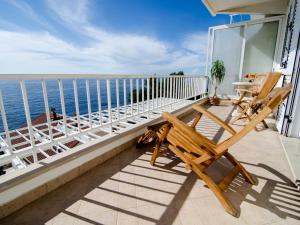 a balcony with chairs and a view of the ocean at Apartment Paco in Dubrovnik