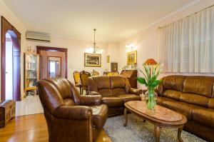a living room with leather furniture and a table at Apartment Paco in Dubrovnik