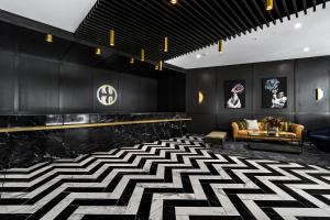 a lobby with a black and white patterned floor at Koko Broadbeach in Gold Coast