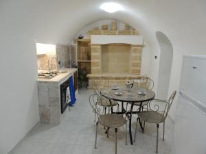 a dining room with a table and chairs in a kitchen at Dimora dell'Isola Gallipoli in Gallipoli +19 photos
