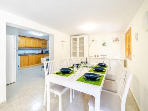 a white dining room with a white table and chairs at Villa Cala Santanyí Beach House JM by Interhome in Santanyi +30 photos