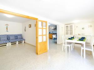 a kitchen and dining room with a table and chairs at Villa Cala Santanyí Beach House JM by Interhome in Santanyi