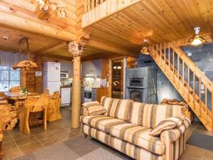 a living room with a couch and a staircase at Holiday Home Väinämöinen by Interhome in Tohmajärvi