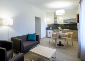 a living room with a couch and a table at Mas Pere Pau in Besalú