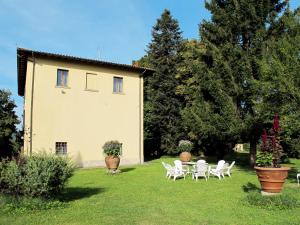 a group of white chairs and a table in a yard at Villa Laura by Interhome in Agna