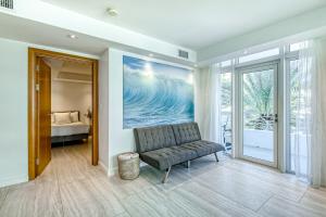 a living room with a couch and a bedroom at Modern Ocean Drive Condo in the Heart of Sobe! in Miami Beach