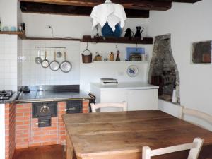 a kitchen with a wooden table and a stove at Holiday Home Casa Lienartova by Interhome in Grimacco