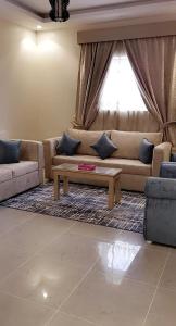 a living room with a couch and a coffee table at Marina Arar Furnished Apartments in Arar