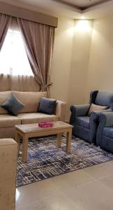 a living room with a couch and a coffee table at Marina Arar Furnished Apartments in Arar