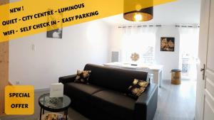 a living room with a couch and a table at Les Nuits d'Anis - Appartements Hypercentre in Le Puy en Velay +123 photos