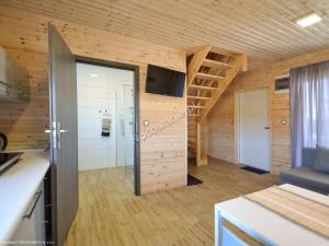 a small room with a staircase in a wooden house at MM Apartments in Niechorze