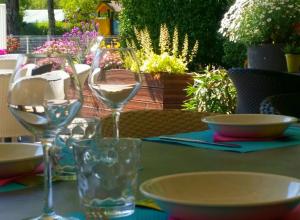 a table with two glasses of white wine on it at Camping La Digue in Chauzon +33 photos